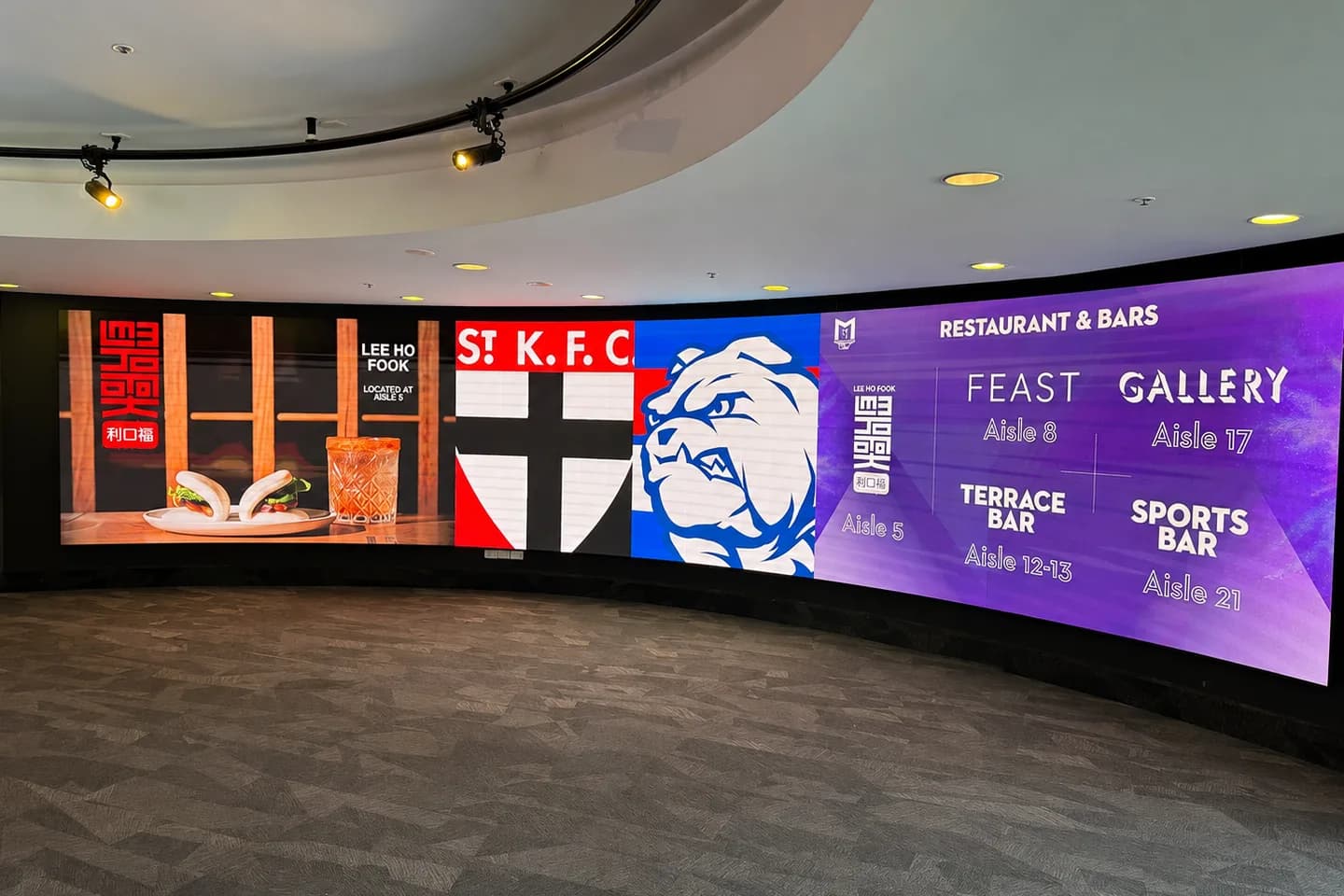 Curved multi-panel LED video wall in a venue foyer
