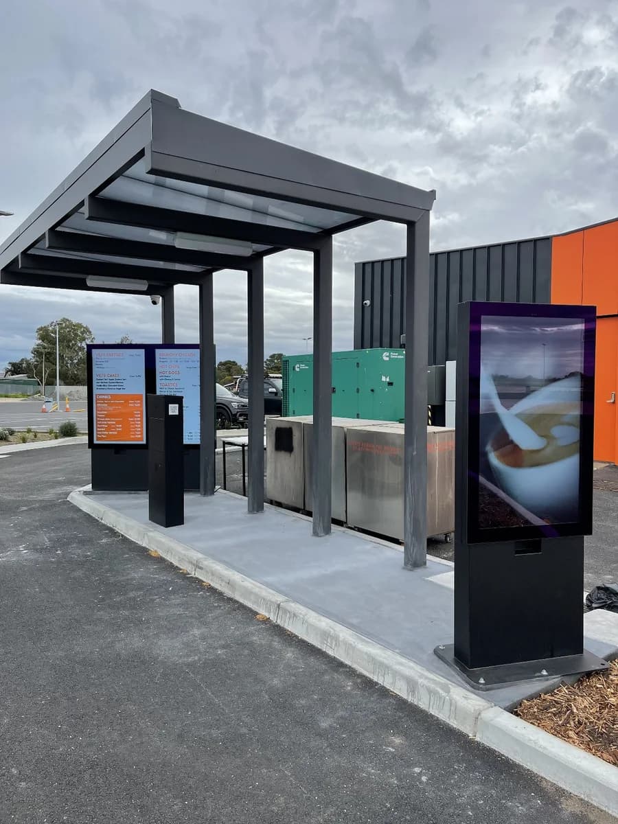Freestanding commercial LCD display in a retail space, seen in full