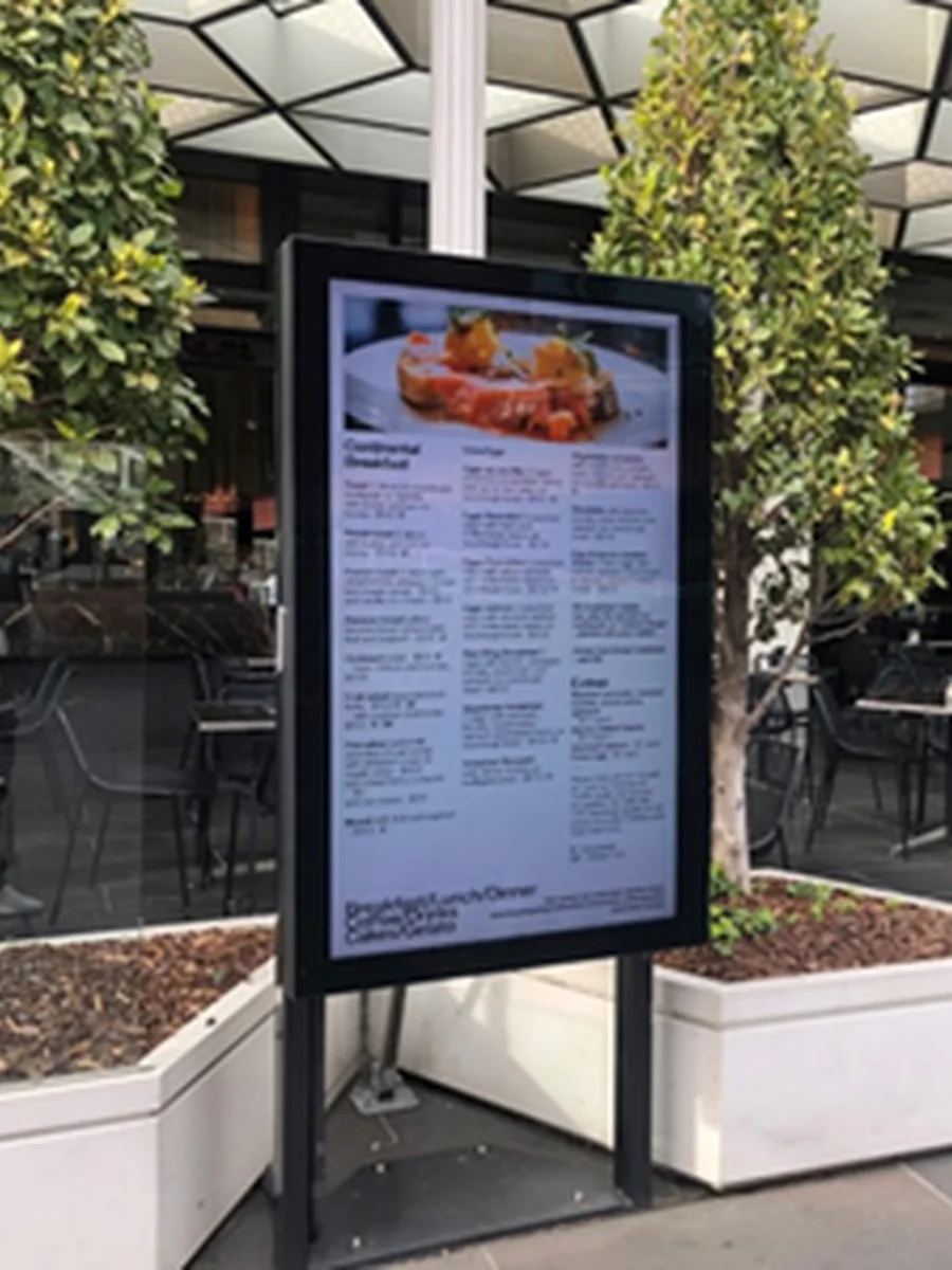 Freestanding weather rated blade display showing a menu in an outdoor dining precinct