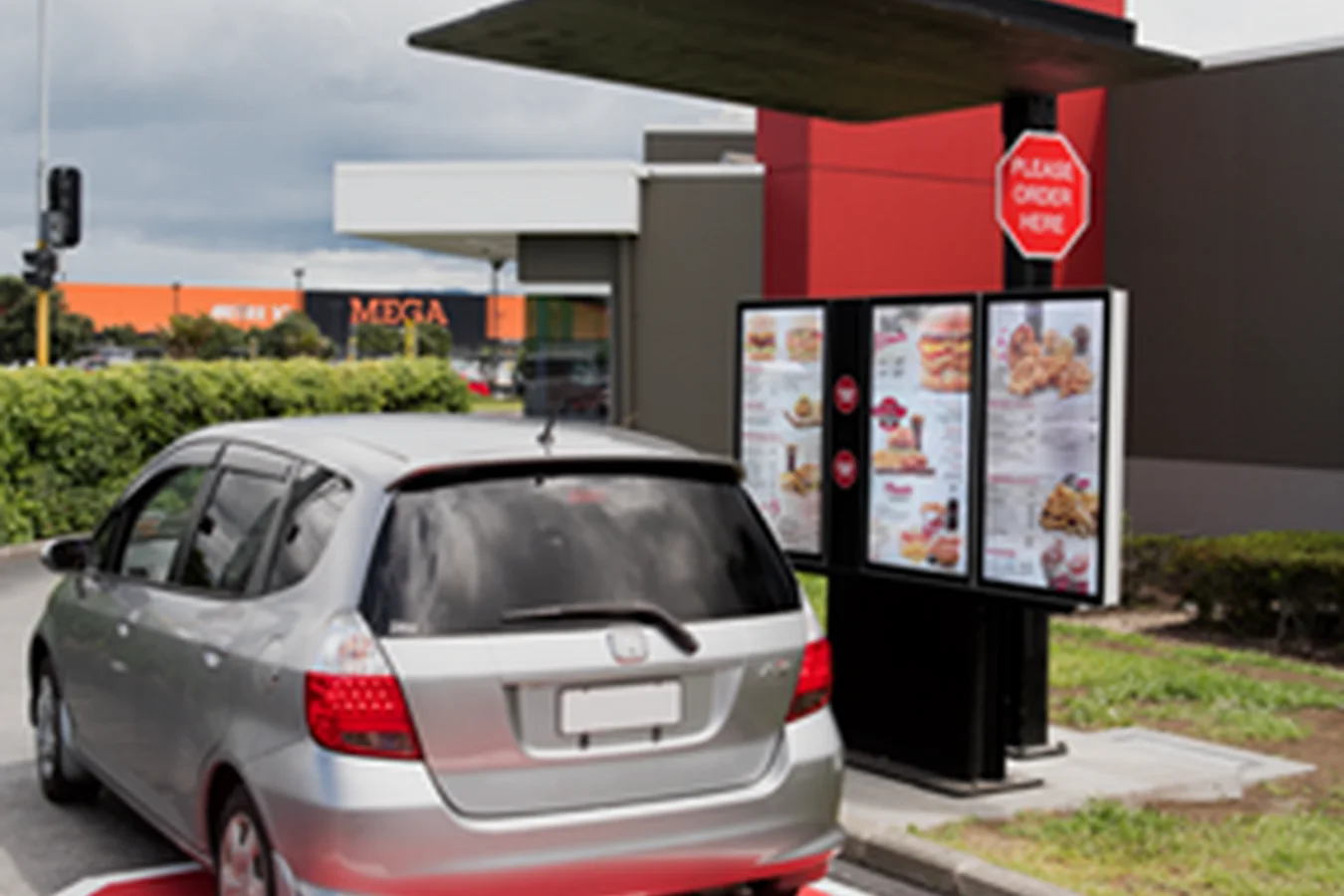 High brightness drive-thru order point beside a vehicle lane at a quick service restaurant