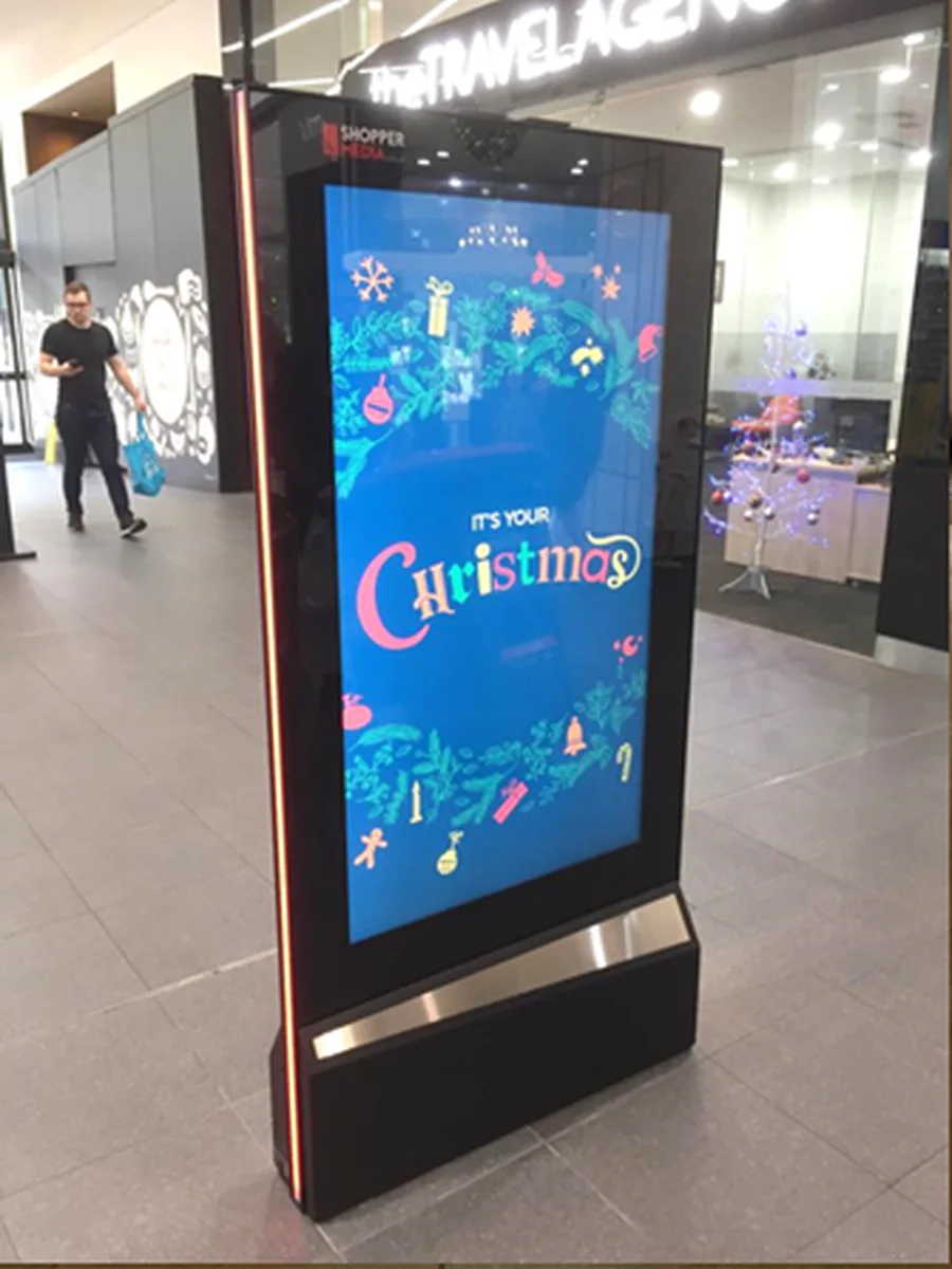 Freestanding digital blade display running seasonal content inside a retail centre