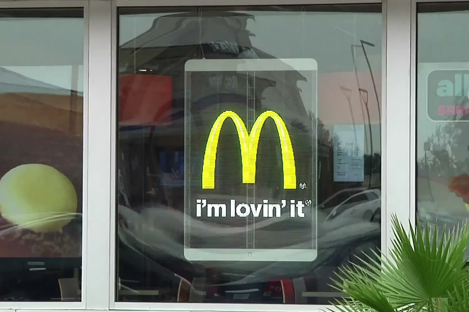 Transparent LED window display running content on a glass shopfront
